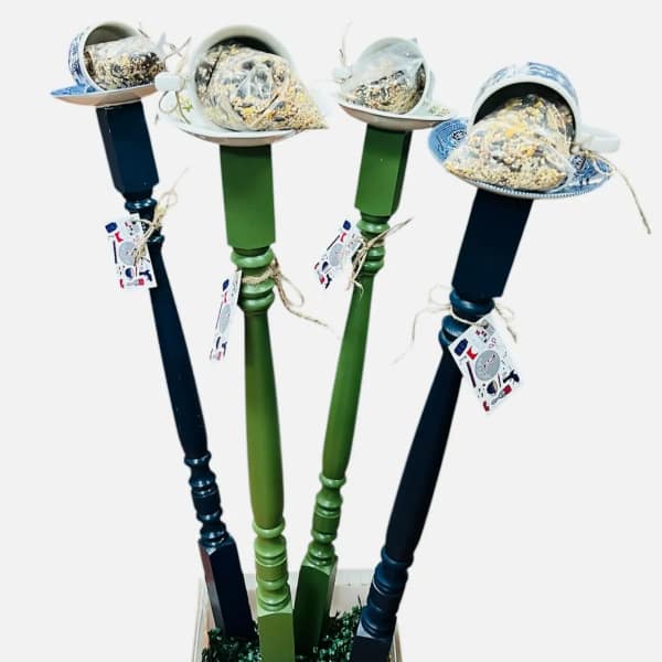 Four decorative pedestal stands topped with wrapped snack cones