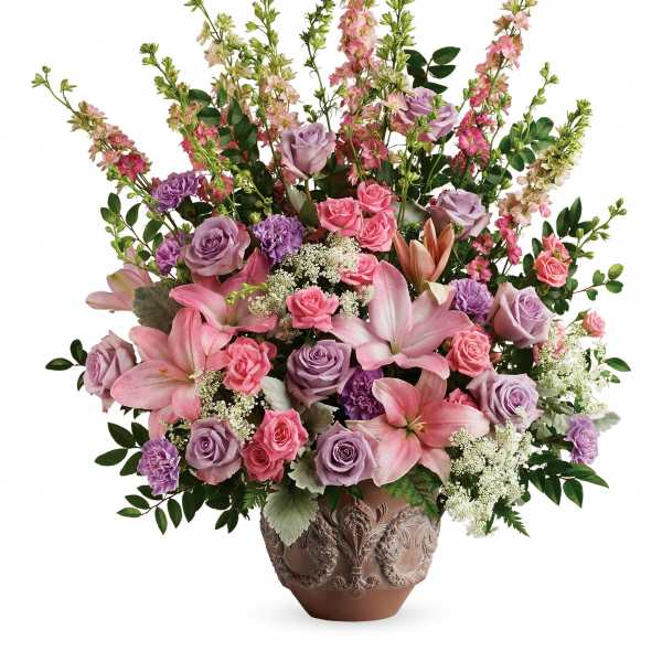 Large pink and lavender floral arrangement in a decorative vase