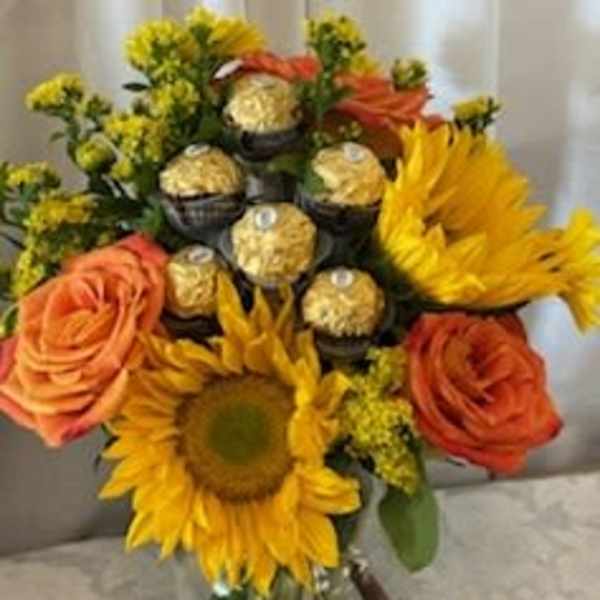 Bouquet of sunflowers, orange roses, and gold-wrapped chocolates