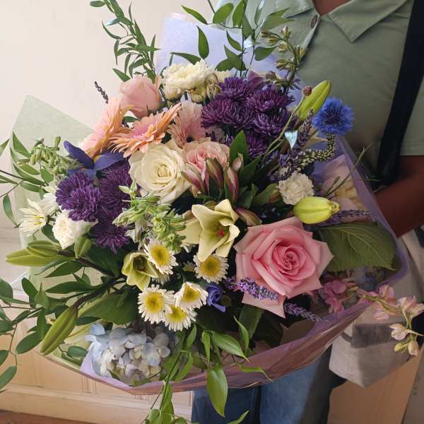 Mixed bouquet with pink roses, purple chrysanthemums, and white lilies