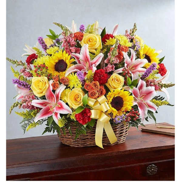Basket of mixed flowers with lilies, roses, and sunflowers