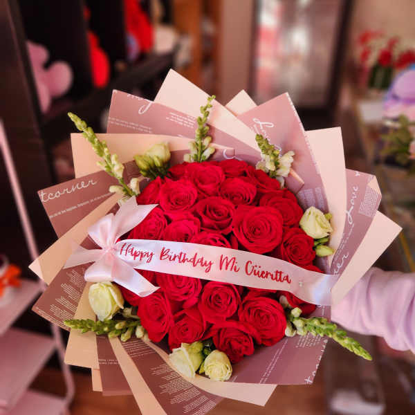 Red rose bouquet with a birthday ribbon and pale wrapping
