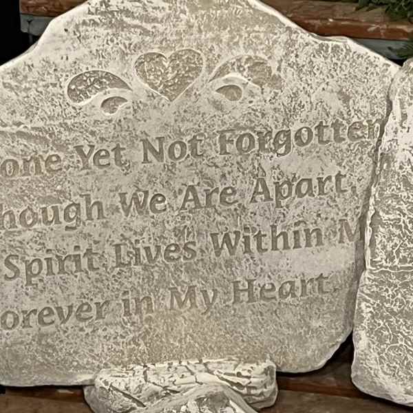 Decorative stone plaque with a heart and engraved quote