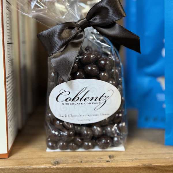 Bag of dark chocolate espresso beans tied with a black ribbon