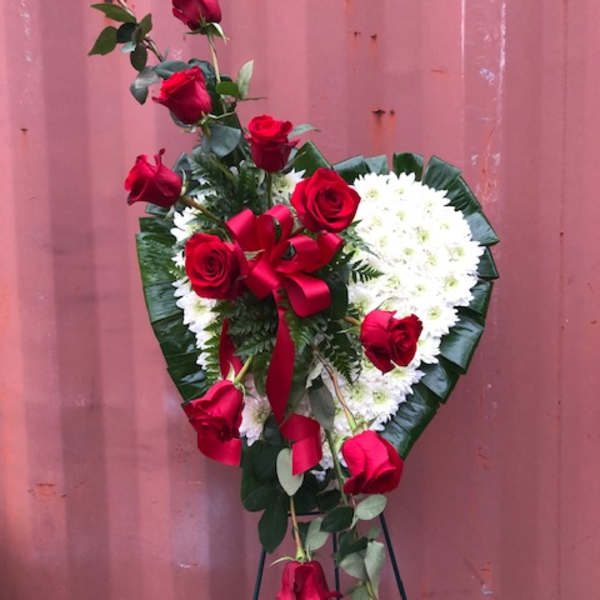 Heart-shaped standing spray with red roses and white flowers