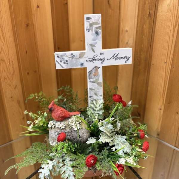 Memorial cross arrangement with red flowers and greenery