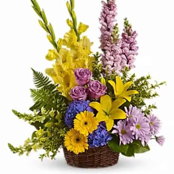 Colorful mixed flower arrangement in a wicker basket