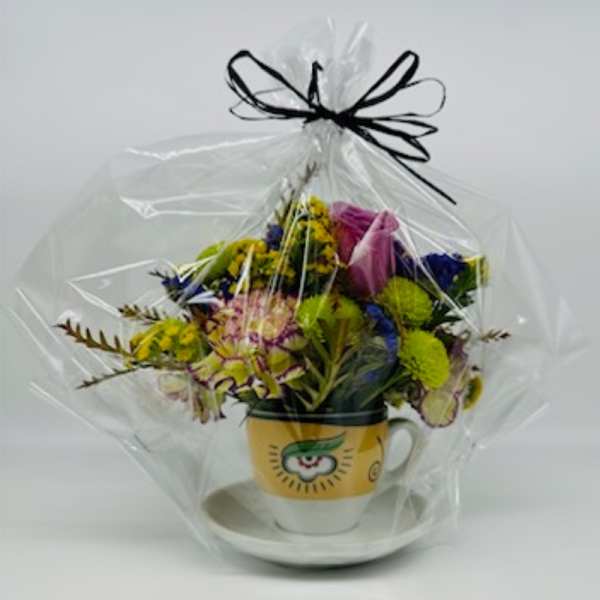Mixed bouquet in a yellow mug with a clear wrap and black ribbon