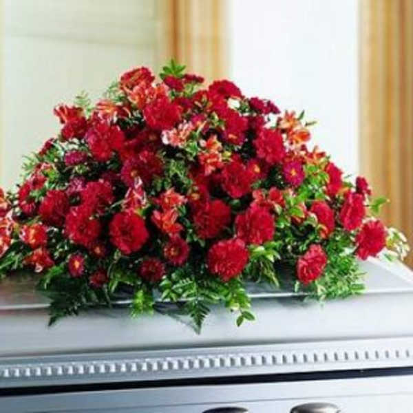 Large red floral spray on a casket