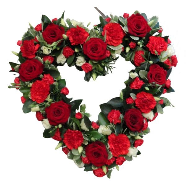 Heart-shaped floral wreath with red roses and carnations