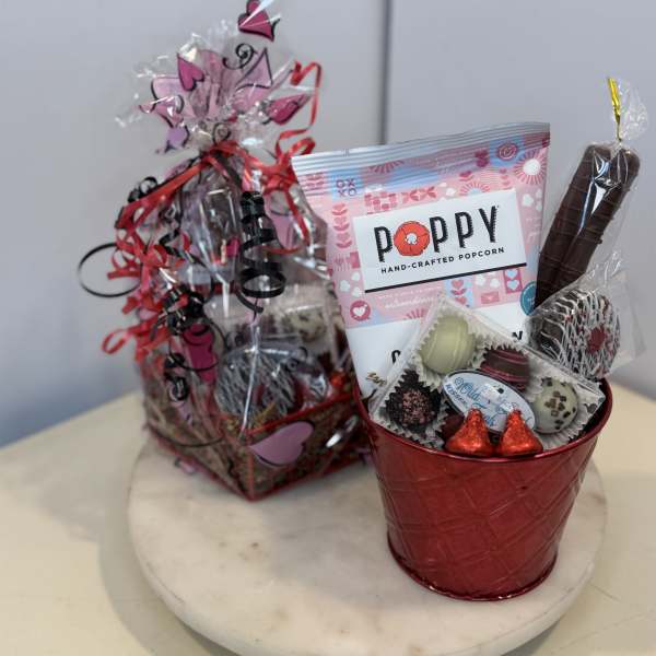 Gift basket with popcorn, chocolates, and a red metal bucket