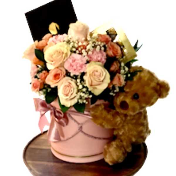 Pink and peach rose bouquet in a pink hatbox with a teddy bear