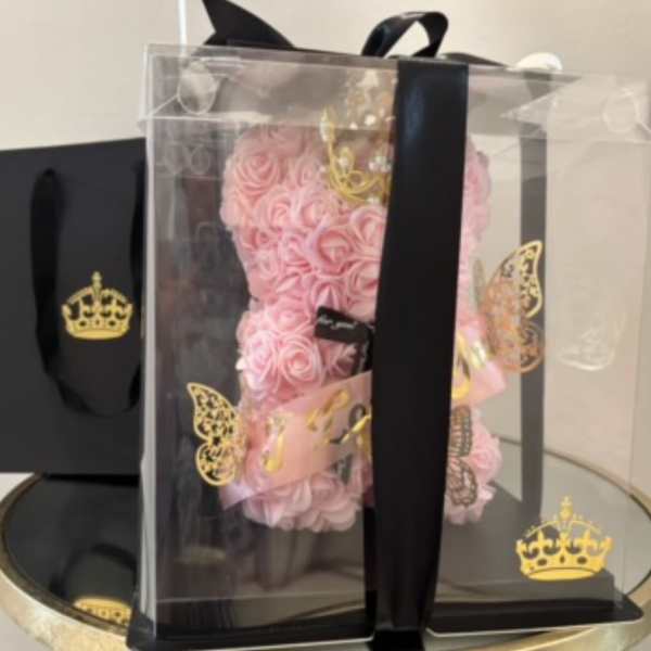 Pink rose teddy bear in a clear gift box with black ribbon