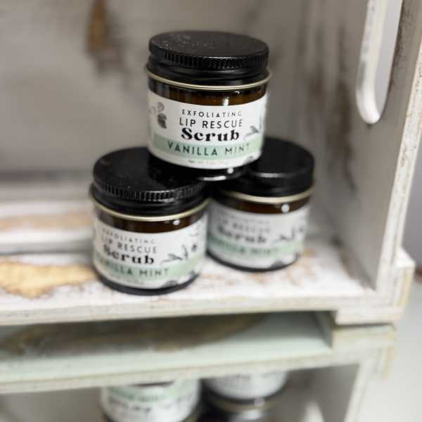 Three jars of vanilla mint lip scrub stacked on a shelf
