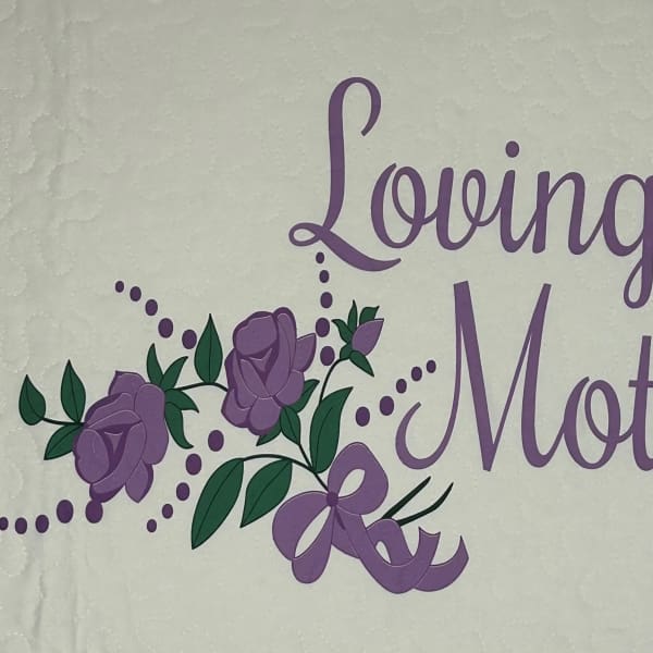 Purple "Loving Mother" text with rose graphics on a quilted white background