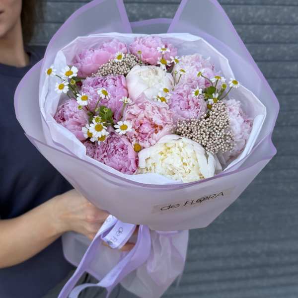 Pink and white bouquet wrapped in lavender paper