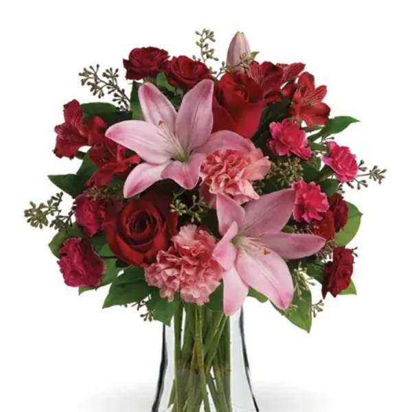 Red and pink mixed bouquet in a clear glass vase