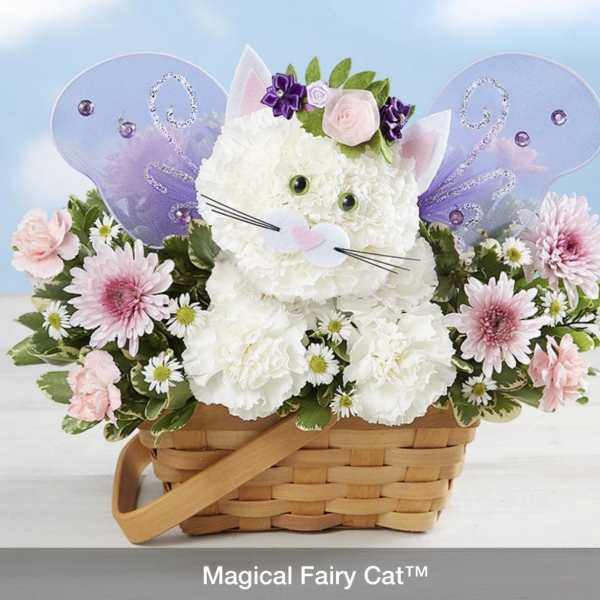 White floral cat arrangement in a wicker basket with purple fairy wings
