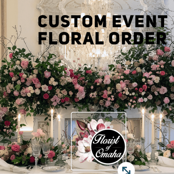Large floral event display with pink and white roses and candles