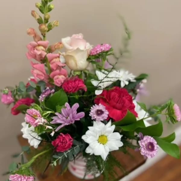 Mixed bouquet with pink, white, and purple flowers in a vase