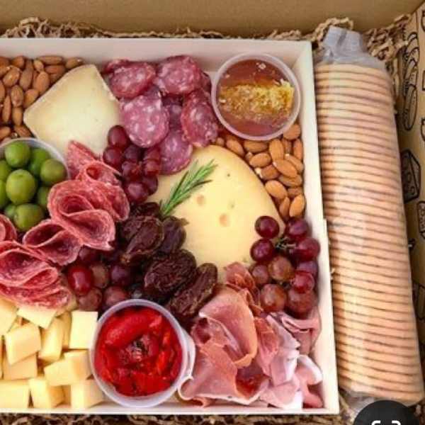 Gift basket with wine, cheese, meats, grapes, nuts, and crackers