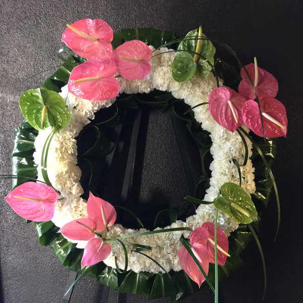 Circle of white mums with pink & green anthurium with Ti leaves surround wreath - F30014