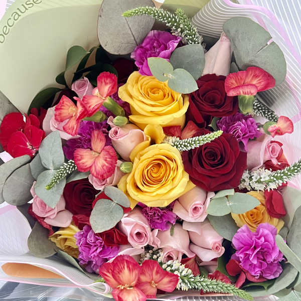 Bouquet of roses, carnations, and pink flowers with eucalyptus