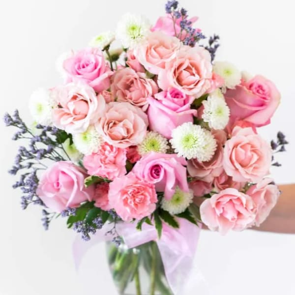Pink and white rose bouquet in a clear glass vase