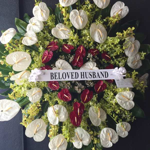 Red heart shaped wreath surrounded by Anthuriums and Orchids - F30010