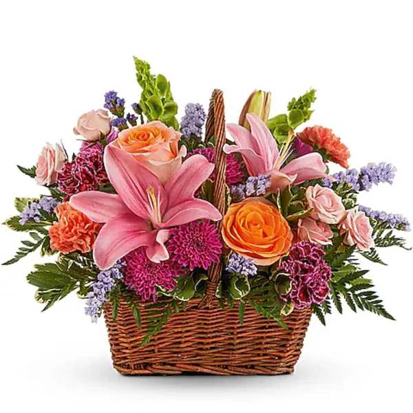 Basket arrangement with pink lilies, roses, and purple flowers