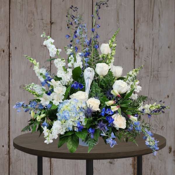 Blue and white floral arrangement in a vase on a table