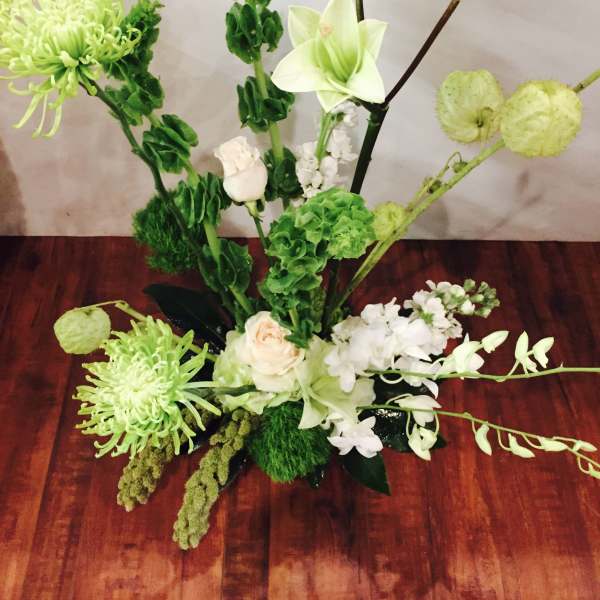 Green and white floral arrangement with lilies and chrysanthemums