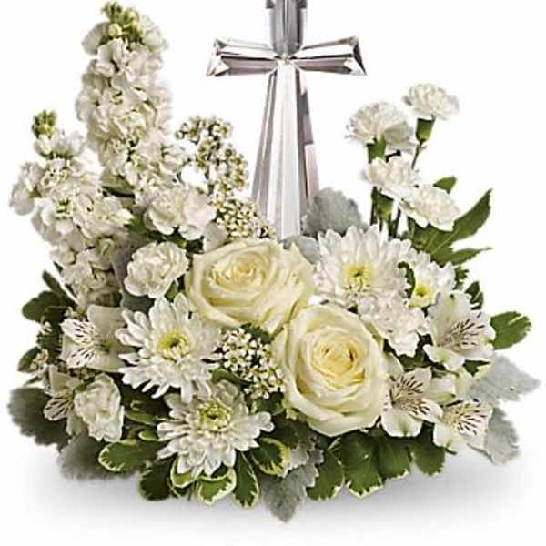 White floral cross arrangement with a silver ribbon bow