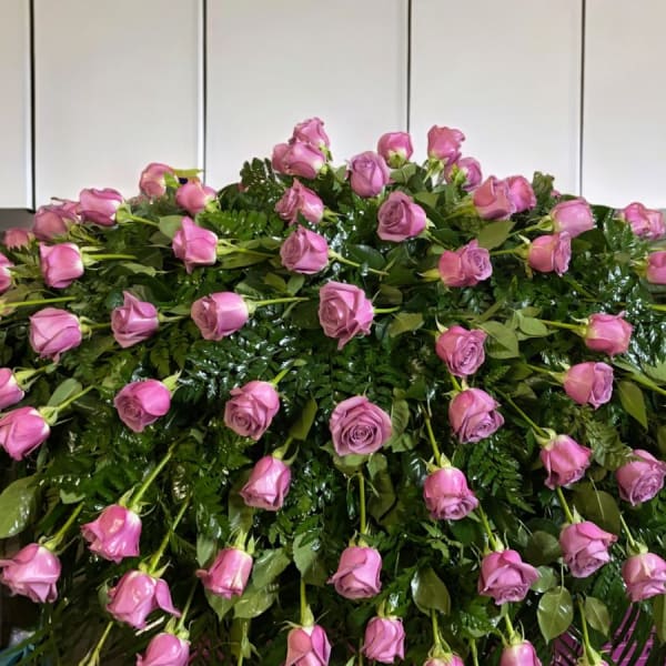 Large arrangement of pink roses over dense greenery