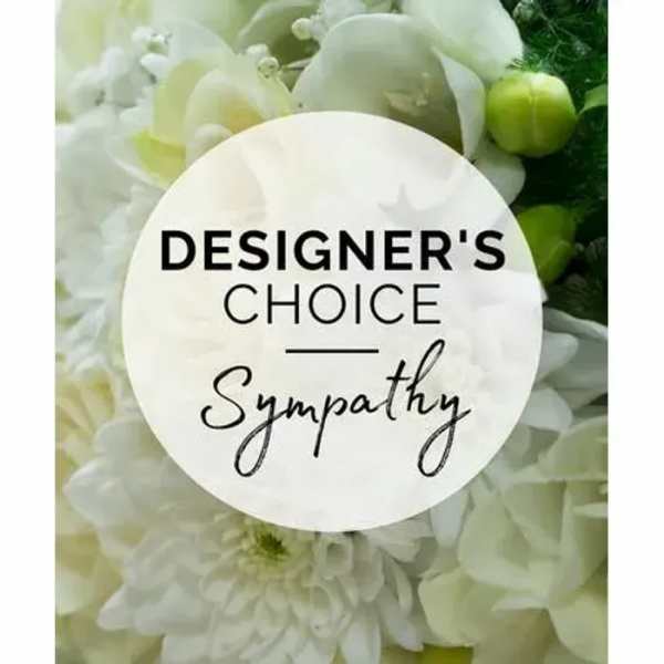 White floral sympathy arrangement with a designer's choice sign