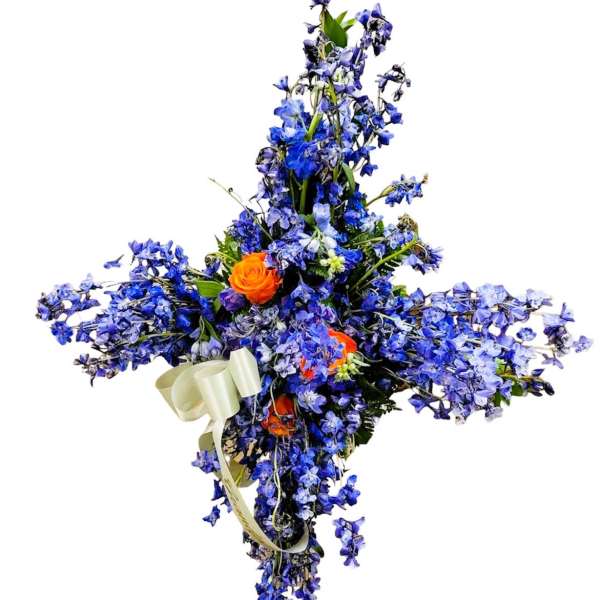 Blue floral cross with orange roses and a ribbon bow