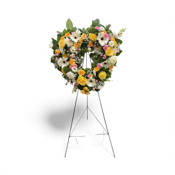 Heart-shaped floral wreath on a standing easel