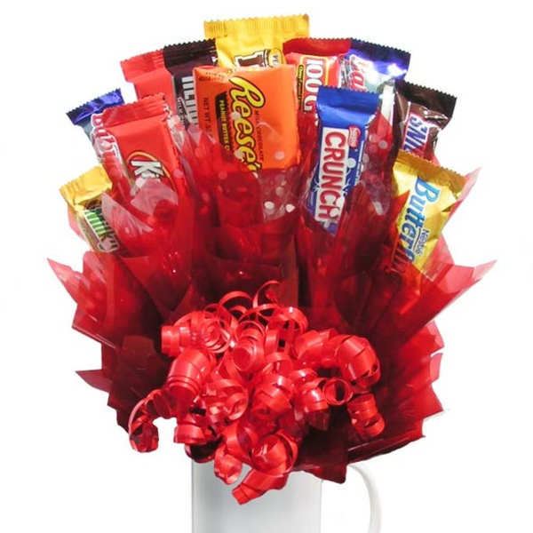 Candy bars arranged in a red gift bouquet in a white mug