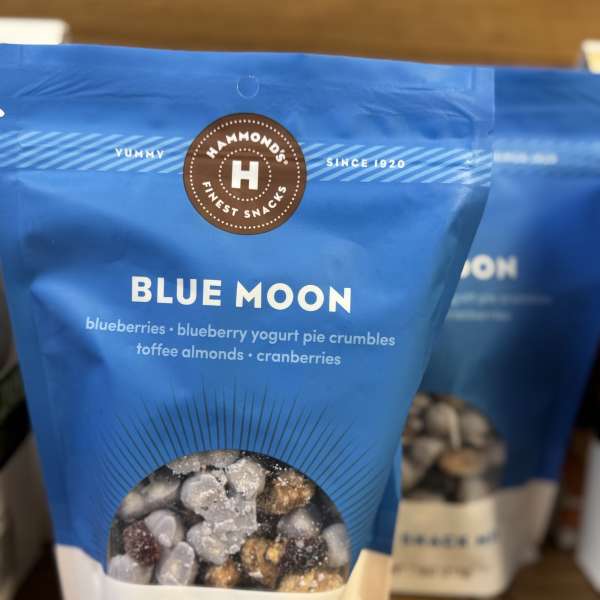 Blue snack mix bag with a clear window showing nuts and dried fruit