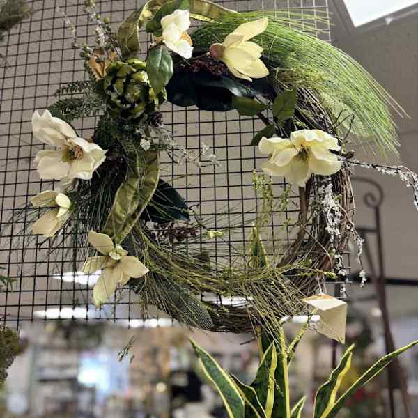 Floral wreath with pale cream flowers and long green grasses