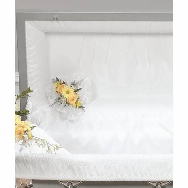 White casket with small yellow floral sprays