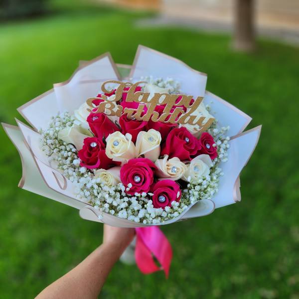 Bouquet of pink and white roses with a Happy Birthday topper