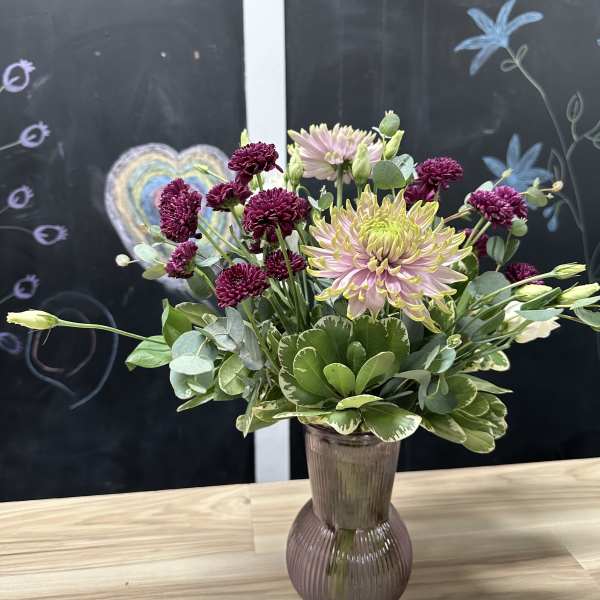 Mixed chrysanthemum bouquet in a ribbed glass vase