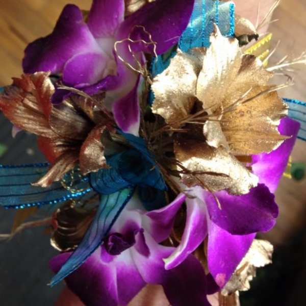 Purple orchid corsage with gold and blue ribbon accents