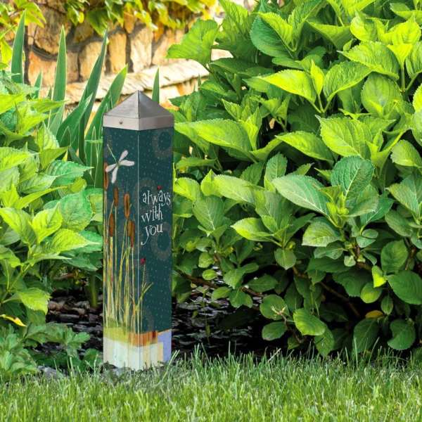 Memorial garden marker among green shrubs with "always with you" text