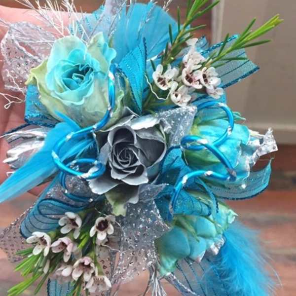 Blue and silver bouquet with roses and small white flowers