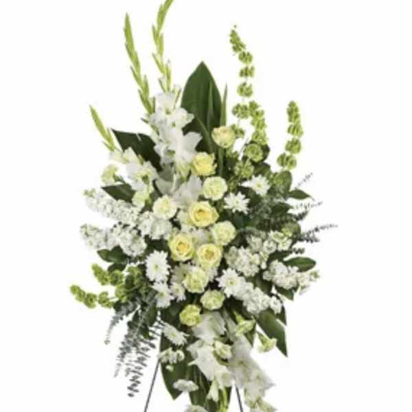 Tall white and pale yellow funeral spray on a standing easel
