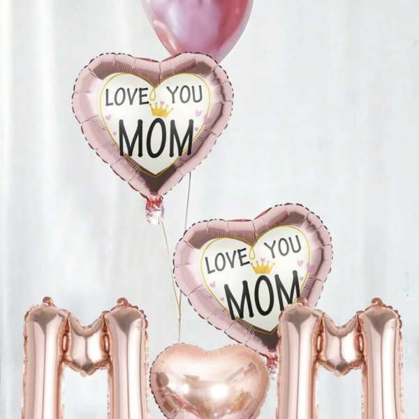Pink heart balloons reading "Love You Mom" with rose-gold "MOM" balloons and balloon clusters