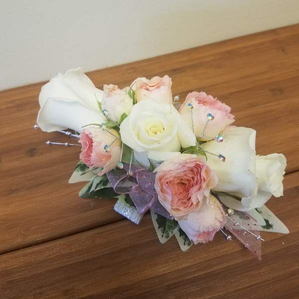 Small bouquet of white and blush roses with ribbon and jeweled picks