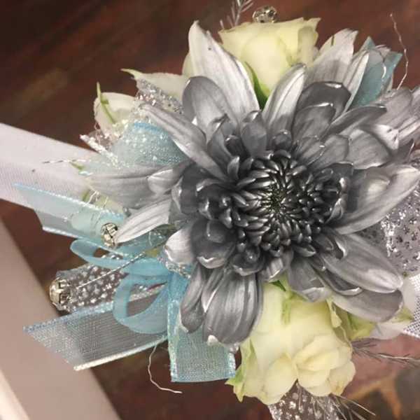 Silver flower bouquet with white roses and blue ribbon accents